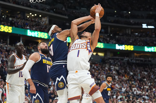 Denver Nuggets guard Bruce Brown, second from front right, fouls Phoenix Suns guard Devin Booker (1) who was driving to the basket in the first half of an NBA basketball game Saturday, Oct. 25, 2025, in Denver. (AP Photo/David Zalubowski) Denver Nuggets guard Bruce Brown, second from front right, fouls Phoenix Suns guard Devin Booker (1) who was driving to the basket in the first half of an NBA basketball game Saturday, Oct. 25, 2025, in Denver. (AP Photo/David Zalubowski)