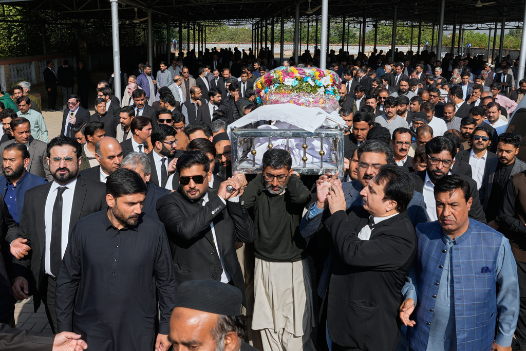 Mourners carry the coffin of lawyer Zubair Aslam Ghumman, who was killed in Tuesday's suicide bombing outside the gates of a district court, during a funeral prayer, in Islamabad, Pakistan, Wednesday, Nov. 12, 2025. (AP Photo/Anjum Naveed)
