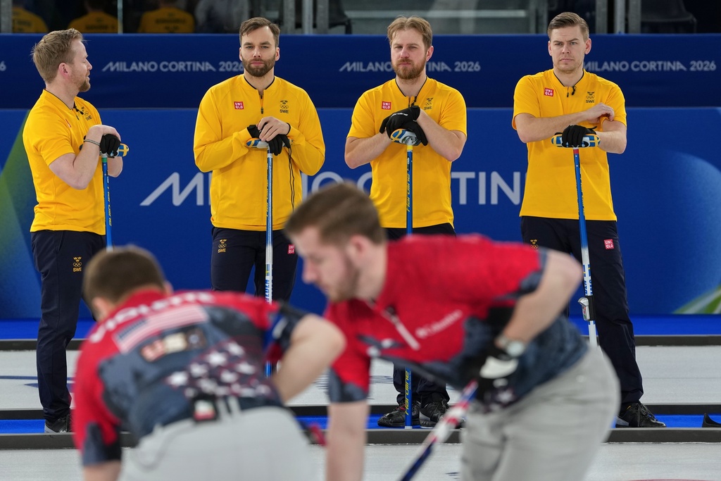 Sweden's Niklas Edin, Oskar Eriksson, Rasmus Wranaa, and Christoffer Sundgren confer during the men's curling round robin session against Switzerland, at the 2026 Winter Olympics, in Cortina d'Ampezzo, Italy, Tuesday, Feb. 17, 2026. (AP Photo/Misper Apawu)