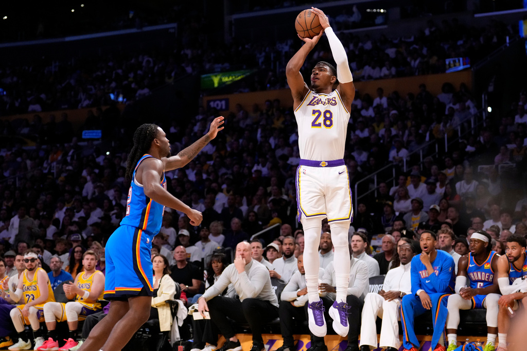 Los Angeles Lakers forward Rui Hachimura, right, shoots as Oklahoma City Thunder guard Cason Wallace defends during the first half of Game 3 in a second-round NBA basketball playoffs series Saturday, May 9, 2026, in Los Angeles. (AP Photo/Mark J. Terrill)