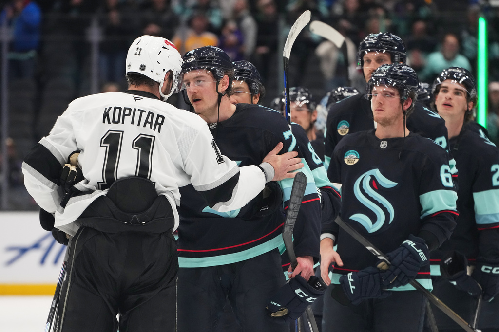 The Seattle Kraken, including center Bobby McMann, line up to greet Los Angeles Kings center Anze Kopitar (11) after a Kings win in an NHL hockey game Monday, April 13, 2026, in Seattle. (AP Photo/Lindsey Wasson)