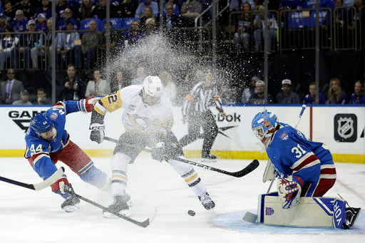 Pittsburgh Penguins defenseman Caleb Jones, center, battles for the puck in between New York Rangers defenseman Vladislav Gavrikov (44) and goaltender Igor Shesterkin (31) in the first period of an NHL hockey game, Tuesday, Oct. 7, 2025, in New York. (AP Photo/Adam Hunger) Pittsburgh Penguins defenseman Caleb Jones, center, battles for the puck in between New York Rangers defenseman Vladislav Gavrikov (44) and goaltender Igor Shesterkin (31) in the first period of an NHL hockey game, Tuesday, Oct. 7, 2025, in New York. (AP Photo/Adam Hunger)
