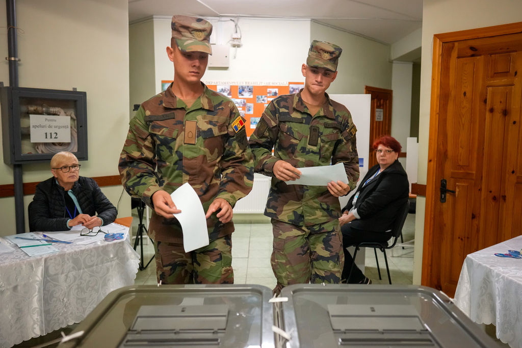 Soldiers prepare to cast their votes during a parliamentary election, in Chisinau, Moldova, Sunday, Sept. 28, 2025. (AP Photo/Vadim Ghirda)