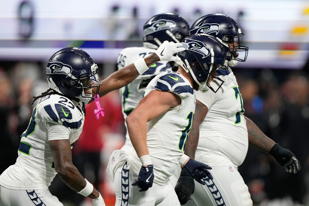 Seattle Seahawks wide receiver Cooper Kupp, center, celebrates his touchdown with wide receiver Rashid Shaheed, left, during the second half of an NFL football game against the Atlanta Falcons, Sunday, Dec. 7, 2025, in Atlanta. (AP Photo/Brynn Anderson)