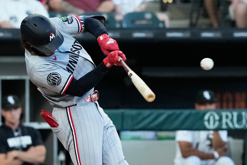Minnesota Twins' Austin Martin hits a one-run single during the fourth inning of a baseball game against the Chicago White Sox in Chicago, Tuesday, May 26, 2026. (AP Photo/Nam Y. Huh)