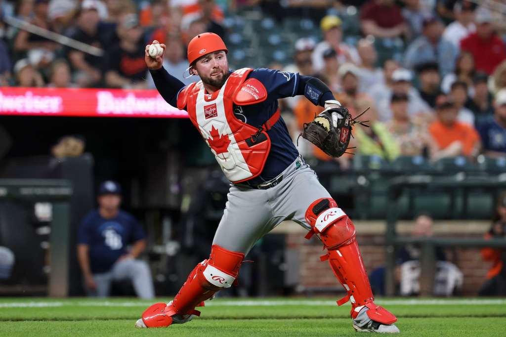Tampa Bay Rays catcher Liam Hicks throws to first base for an out on a ball hit by Baltimore Orioles' Christian Encarnacion-Strand during the second inning of baseball game in Baltimore, Saturday, Aug. 22, 2026. (AP Photo/Terrance Williams)