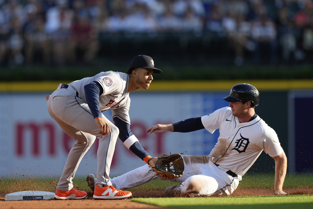 Detroit Tigers' Colt Keith, right, slides against Houston Astros shortstop Jeremy Pena, left, to steal second base during the first inning of a baseball game, Monday, Aug. 18, 2025, in Detroit. (AP Photo/Ryan Sun)