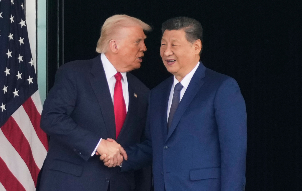 FILE - President Donald Trump, left, and Chinese President Xi Jinping, shake hands after their U.S.-China summit talk at Gimhae International Airport Jinping in Busan, South Korea, Oct. 30, 2025. (AP Photo/Mark Schiefelbein, File)