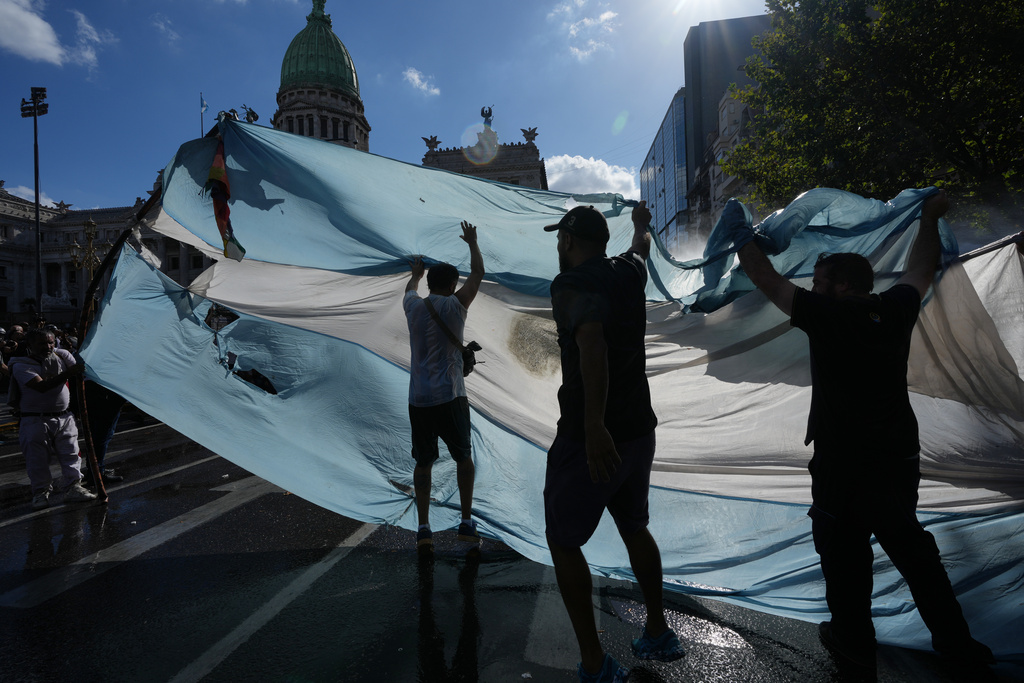 Protesters rally during a march by trade unions and opposition groups against a labor reform bill proposed by President Javier Milei's government in Buenos Aires, Argentina, Thursday, Feb. 19, 2026. (AP Photo/Rodrigo Abd)