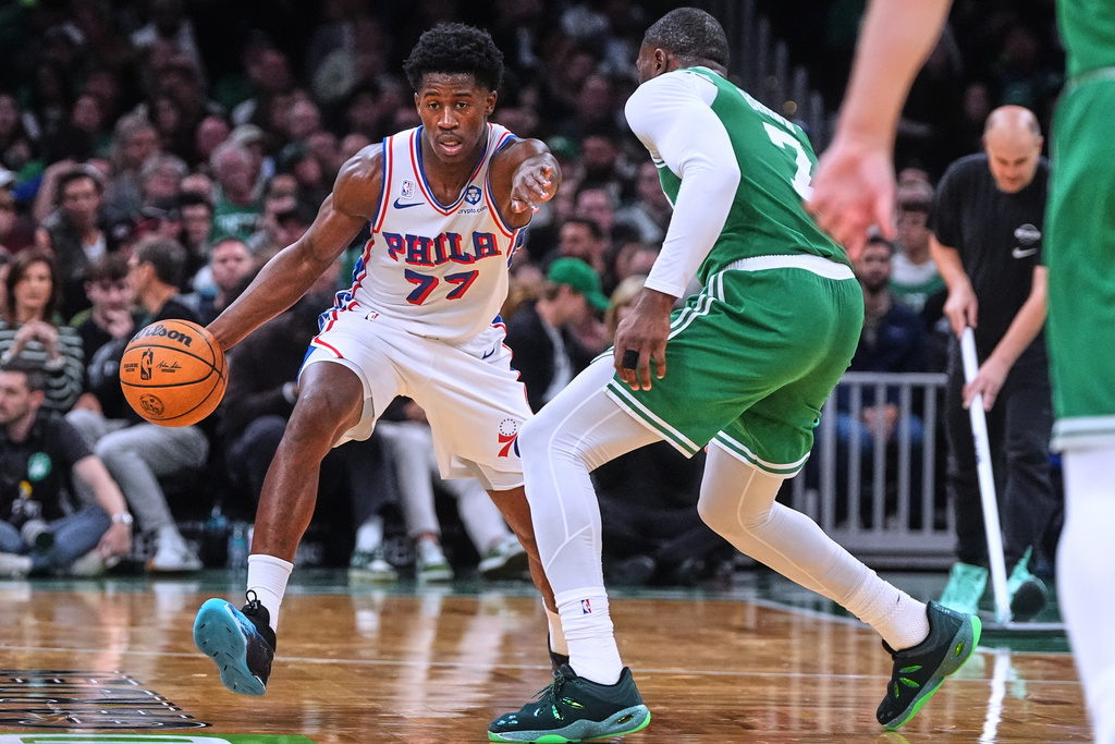 Philadelphia 76ers guard VJ Edgecombe (77) drives to the basket against Boston Celtics guard Jaylen Brown (7) during the second half of an NBA basketball game, Wednesday, Oct. 22, 2025, in Boston. (AP Photo/Charles Krupa)