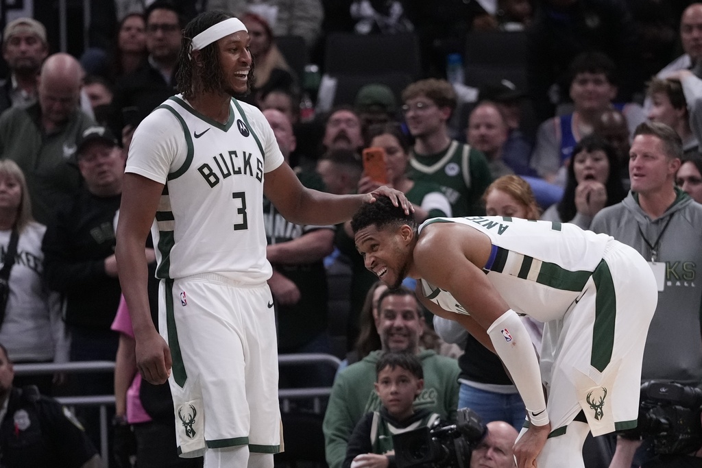 Milwaukee Bucks' Myles Turner rubs Giannis Antetokounmpo's head during the second half of an NBA basketball game against the New York Knicks Tuesday, Oct. 28, 2025, in Milwaukee. (AP Photo/Morry Gash)