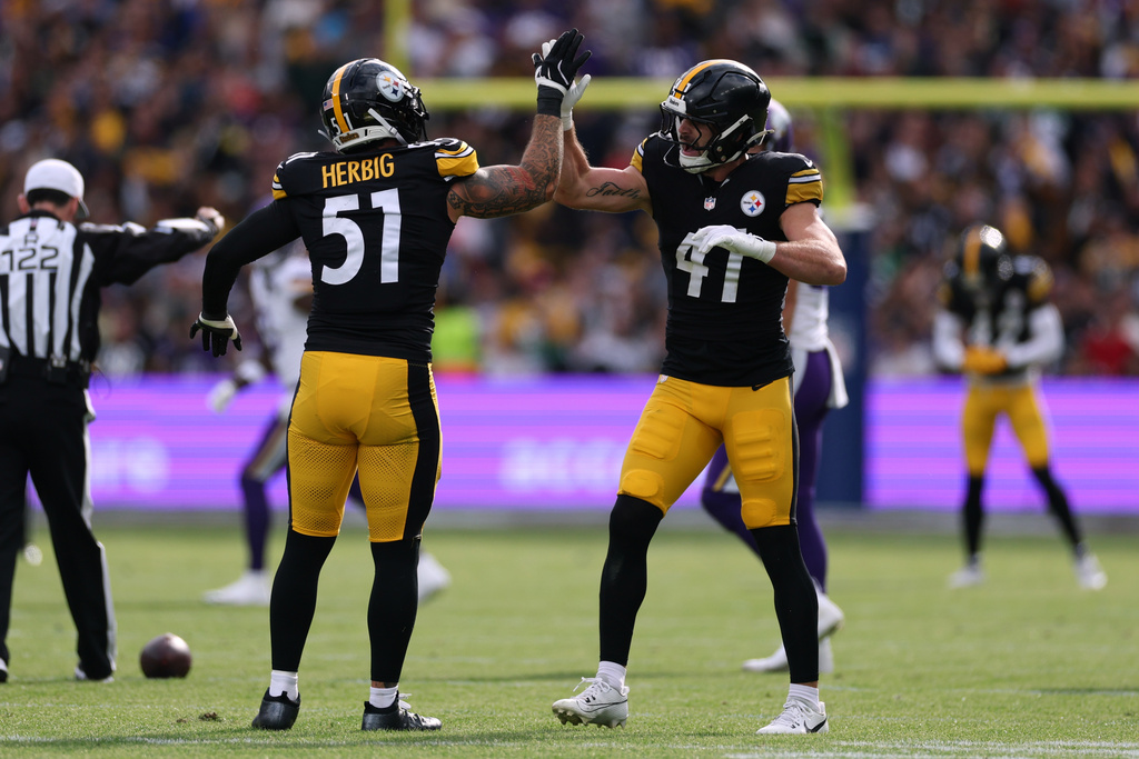 Pittsburgh Steelers linebacker Nick Herbig (51), left, and Pittsburgh Steelers linebacker Payton Wilson (41) celebrate during the NFL football game between Minnesota Vikings and Pittsburgh Steelers at Croke Park stadium in Dublin, Sunday, Sept. 28, 2025.(AP Photo/Ian Walton)