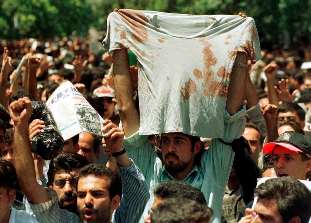 FILE - In this July 12, 1999 file photo, an unidentified student at a rally in Tehran, Iran, holds up the bloody T-shirt of a friend who was injured sometime in the last few days during clashes between police and student demonstrators. (AP Photo/Kamran Jebreili, File)
