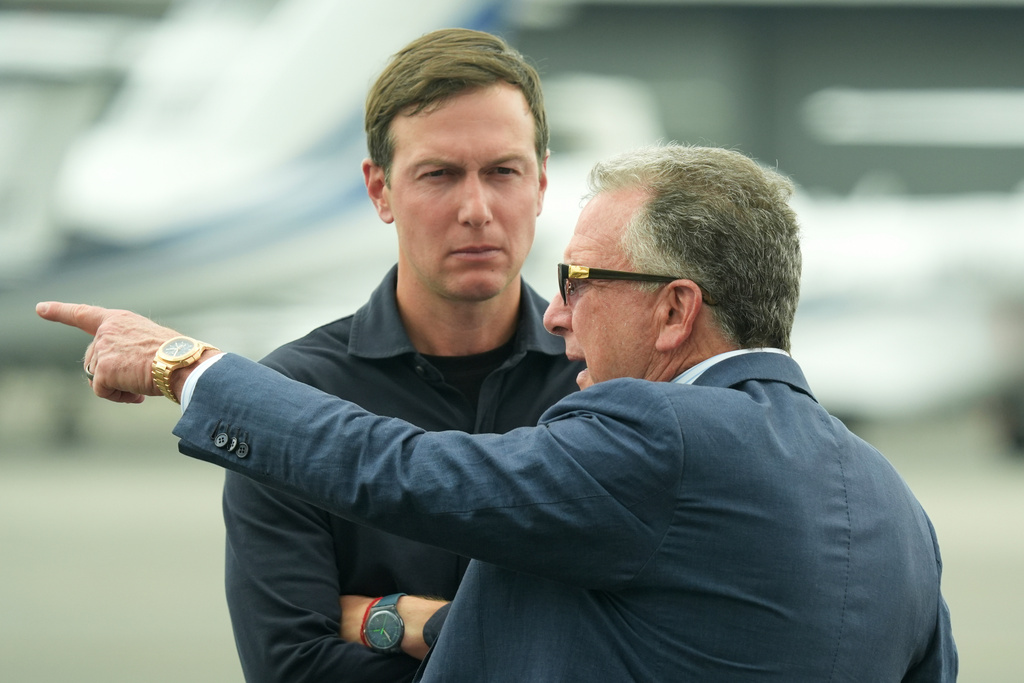 FILE - White House special envoy Steve Witkoff, right, and Jared Kushner wait for the arrival of President Donald Trump at Teterboro Airport in Teterboro, N.J., en route to attend the Club World Cup final soccer match, July 13, 2025. (AP Photo/Jacquelyn Martin, File)
