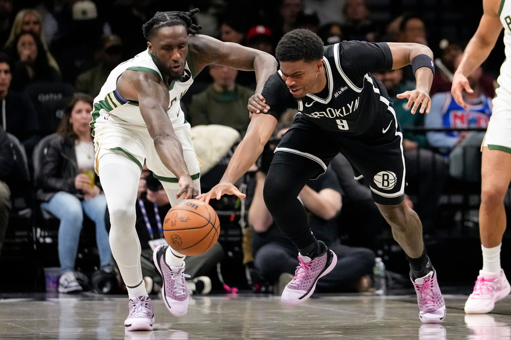 Brooklyn Nets forward E.J. Liddell (9) fights for control of the ball with Milwaukee Bucks forward Taurean Prince (12) during the first half of an NBA basketball game, Tuesday, April 7, 2026, in New York. (AP Photo/Yuki Iwamura)