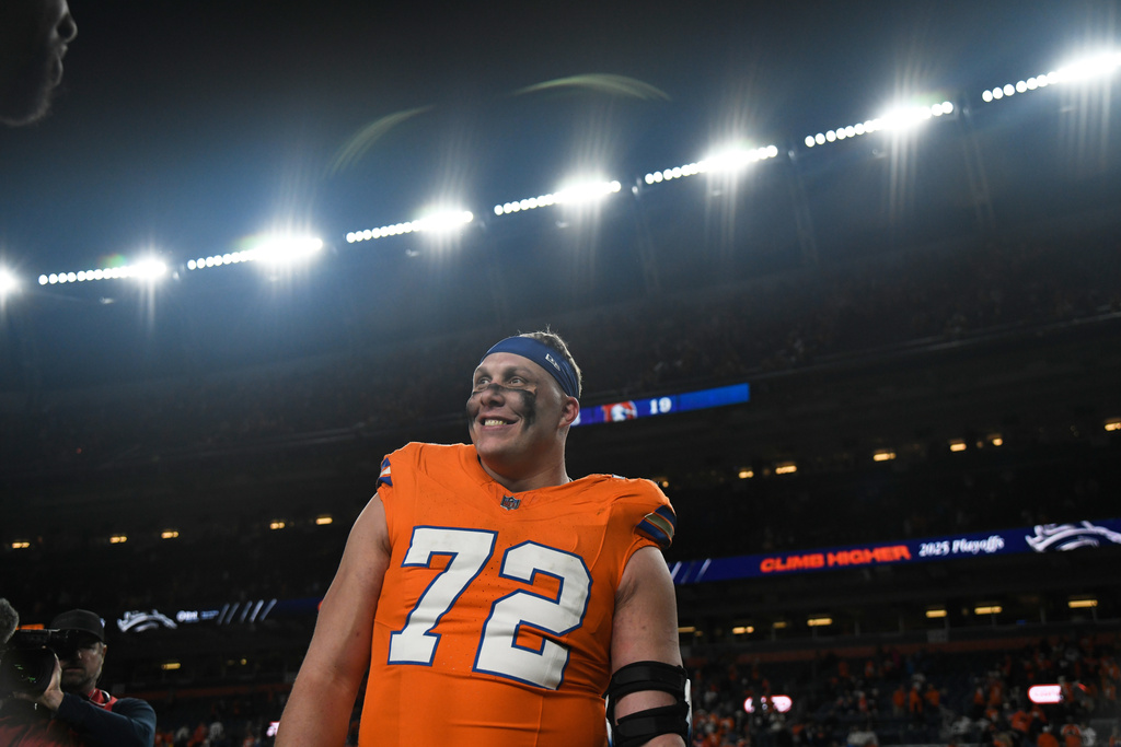 Denver Broncos offensive tackle Garett Bolles smiles as he walks off the field after his team defeated the Los Angeles Chargers in an NFL football game Sunday, Jan. 4, 2026, in Denver. (AP Photo/Eric Lutzens)