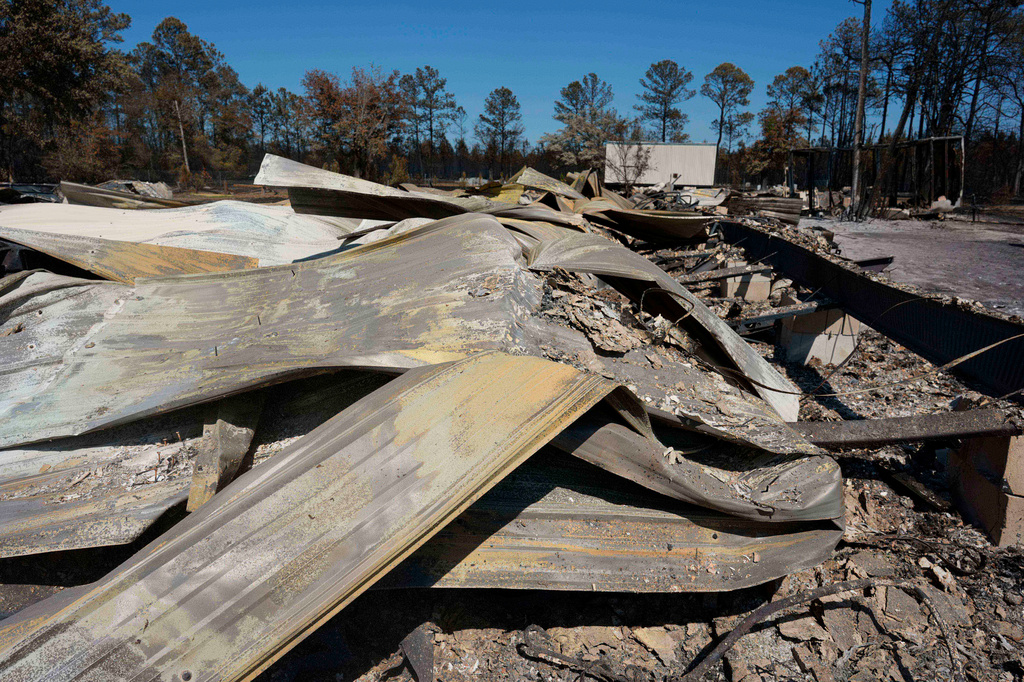 The burned out remains of the Wedding Chapel at covenant acres is seen near the Brantley Highway 82 fire, Thursday, April 23, 2026, near Nahunta, Ga. (AP Photo/Mike Stewart)