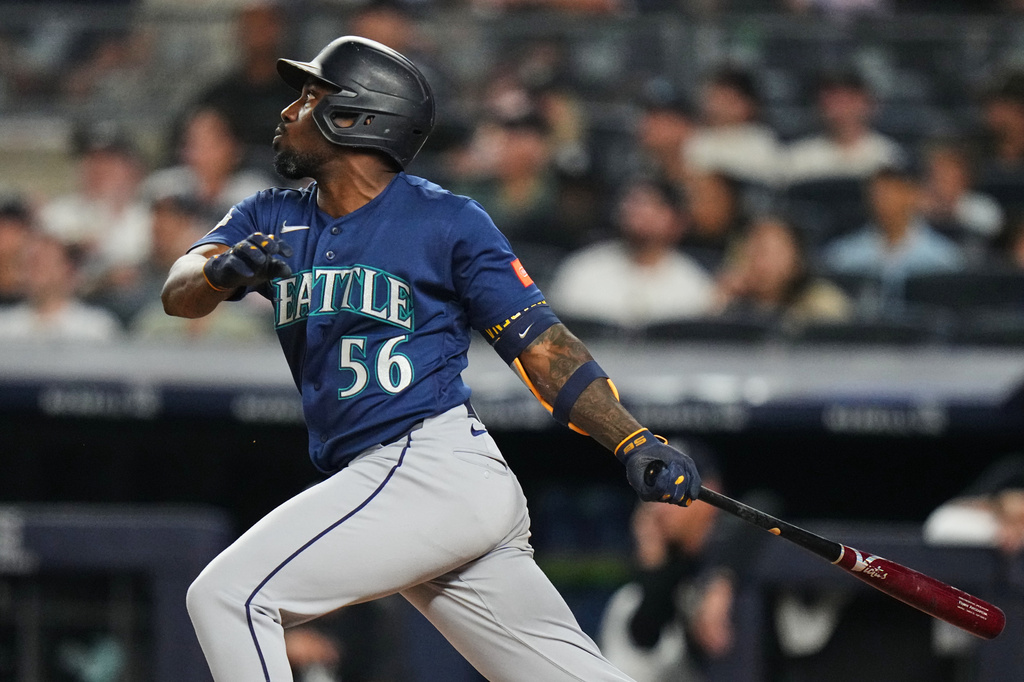 Seattle Mariners' Randy Arozarena (56) follows through on a home run during the sixth inning of a baseball game against the New York Yankees Tuesday, Aug. 11, 2026, in New York. (AP Photo/Frank Franklin II)