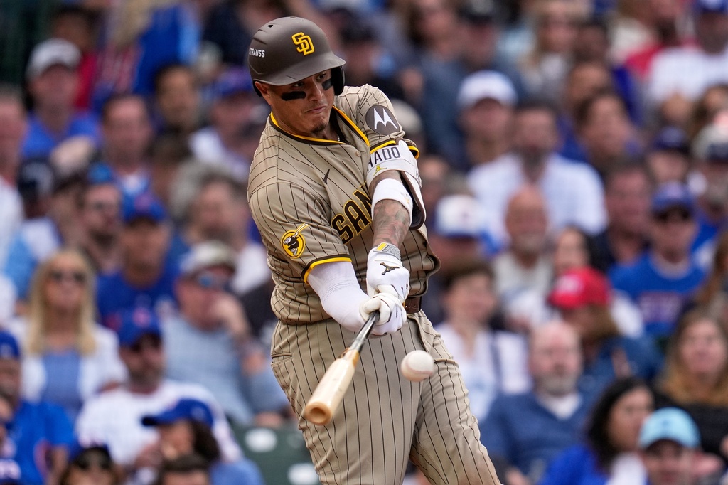 San Diego Padres' Manny Machado hits a two-run home run during the fifth inning of Game 2 of a National League wild card baseball game Wednesday, Oct. 1, 2025, in Chicago. (AP Photo/Erin Hooley)