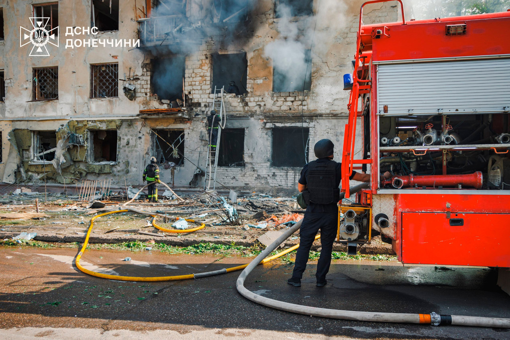 In this photo provided by the Ukrainian Emergency Service, emergency services personnel work to extinguish a fire after a Russian air attack in Kramatorsk, Donetsk region, Ukraine, Tuesday, May 19, 2026. (Ukrainian Emergency Service via AP)