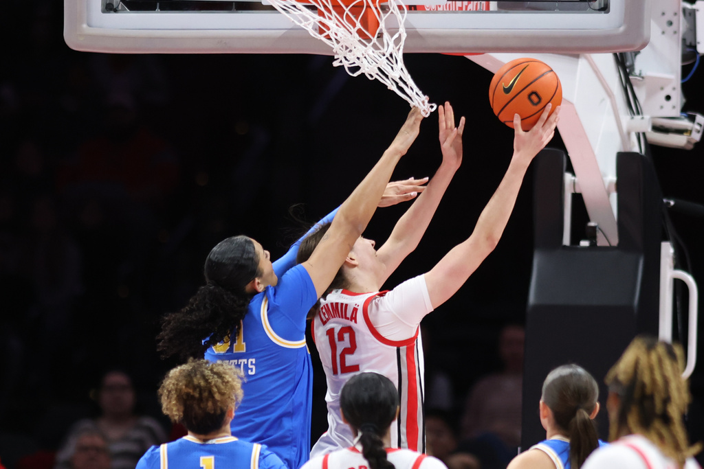 Ohio State center Elsa Lemmila (12) shoots in front of UCLA center Lauren Betts, top left, during the first half of an NCAA college basketball game in Columbus, Ohio, Sunday, Dec. 28, 2025. (AP Photo/Paul Vernon)