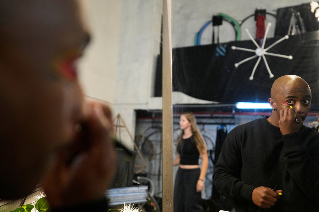 Circus performer Brian Ngobese applies makeup as he prepares for his appearance in The Cirk’s “Worlds Away” show in Johannesburg, Friday, Aug. 28, 2026. (AP Photo/Themba Hadebe)
