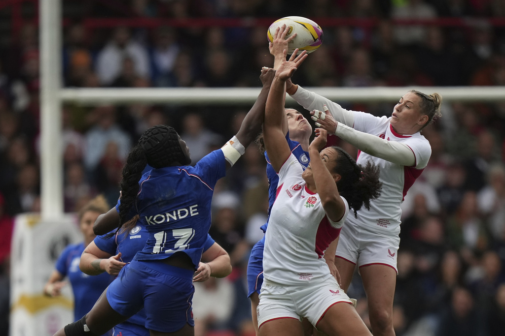 France's Nassira Konde, left, and England's Tatyana Heard jump for the ball during the Women's Rugby World Cup 2025 semifinal match between France and England in Bristol, England, Saturday, Sept. 20, 2025.(AP Photo/Alastair Grant)