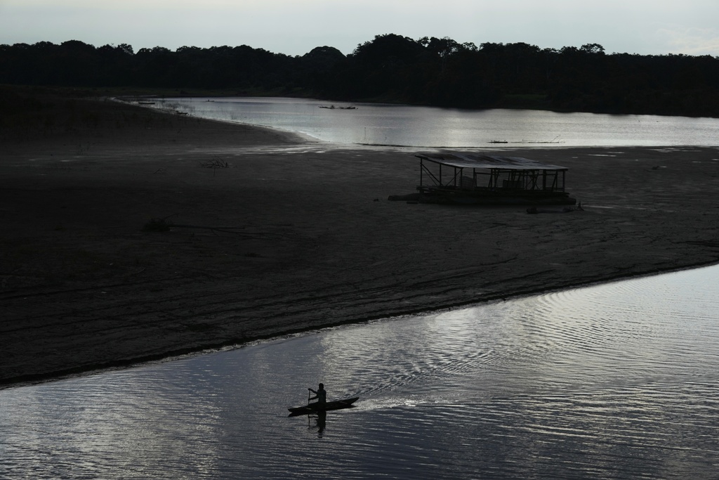 A fisherman paddles his boat on the Amazon river in Puerto Narino, Colombia, Saturday, Sept. 6, 2025. (AP Photo/Fernando Vergara)