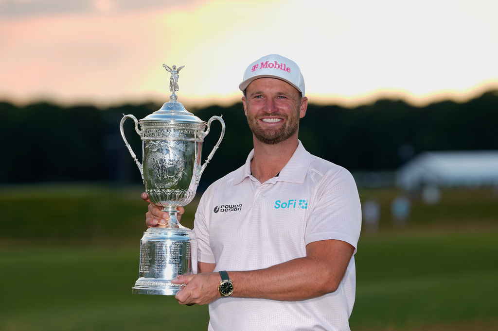 Wyndham Clark holds the trophy after winning the U.S. Open golf tournament at Shinnecock Hills Golf Club in Southampton, N.Y., Sunday, June 21, 2026. (AP Photo/Gerald Herbert)