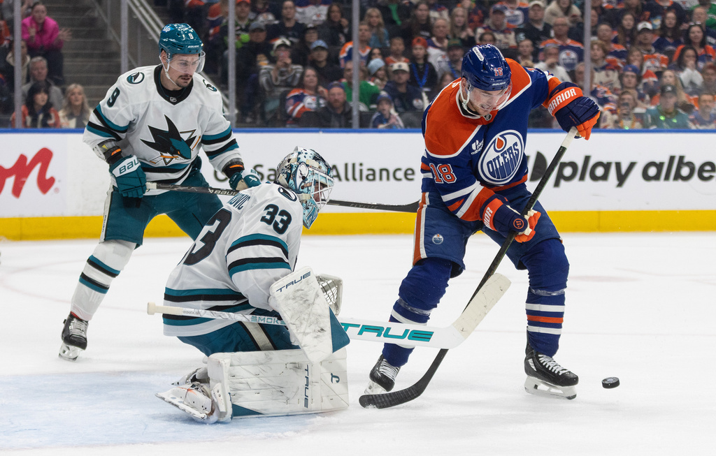 San Jose Sharks goalie Alex Nedeljkovic (33) makes the save on Edmonton Oilers' Zach Hyman (18) during second period NHL action, in Edmonton, on Tuesday March 17, 2026. (Jason Franson/The Canadian Press via AP)