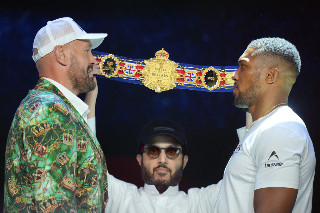 Tyson Fury, left, and Anthony Joshua, right, face off after a Press Conference in London, Wednesday, Sept. 30, 2026, to promote their upcoming fight which will take place at the Principality Stadium in Cardiff on Dec.11.(AP Photo/Kin Cheung)