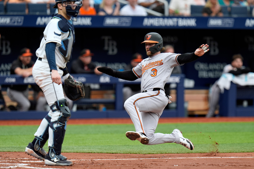 Baltimore Orioles' Taylor Ward (3) scores in front of Tampa Bay Rays catcher Hunter Feduccia on an RBI single by Pete Alonso during the third inning of a baseball game Wednesday, May 20, 2026, in St. Petersburg, Fla. (AP Photo/Chris O'Meara)