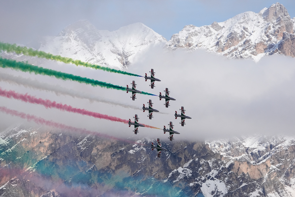 The Italian Frecce Tricolori acrobatic squad flies above during the medal ceremony of an alpine ski, women's super-G race, at the 2026 Winter Olympics, in Cortina d'Ampezzo, Italy, Thursday, Feb. 12, 2026.(AP Photo/Robert F. Bukaty)