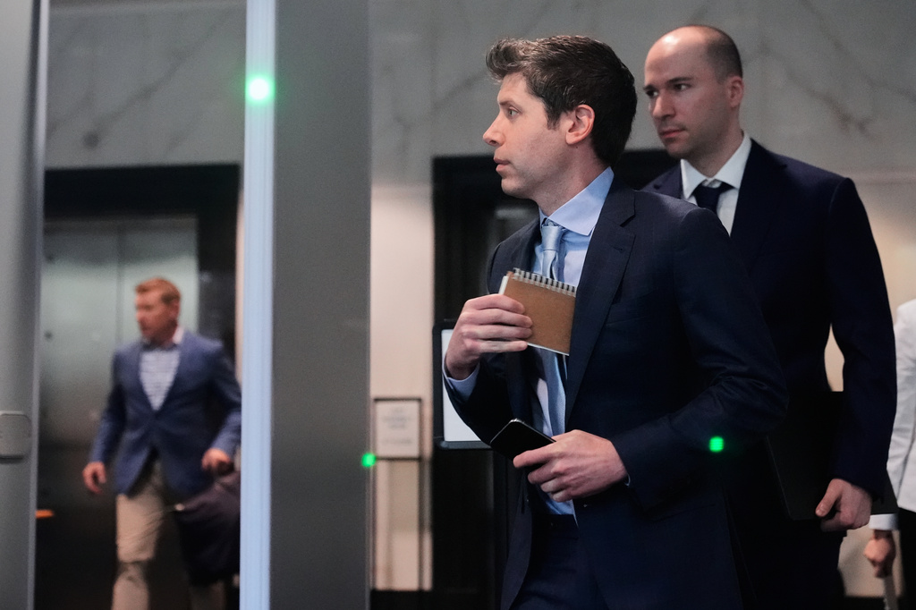 FILE - Sam Altman, center, and OpenAI President Greg Brockman, right, arrive at the U.S. District Court in Oakland, Calif., April 30, 2026. (AP Photo/Godofredo A. Vásquez, File)