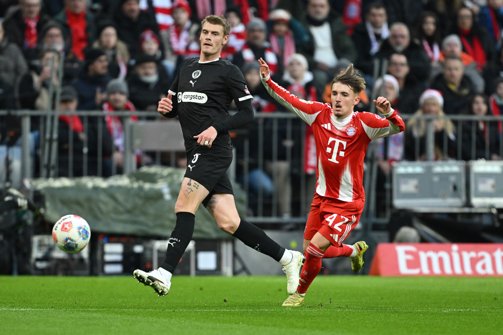 Bayern Munich's Lennart Karl and St. Pauli's Eric Smith, left, in action during the Bundesliga soccer match between Bayern Munich and FC St. Pauli in Munich, Germany, Saturday Nov. 29, 2025. (Sven Hoppe/dpa via AP)