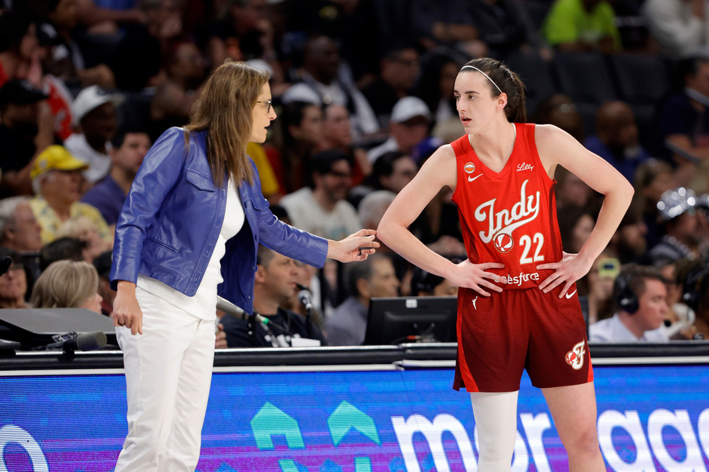 Indiana Fever head coach Stephanie White talks with Indiana Fever guard Caitlin Clark (22) during the first half of an WNBA basketball game against the Las Vegas Aces Sunday, July 12, 2026, in Las Vegas. (Steve Marcus/Las Vegas Sun via AP)