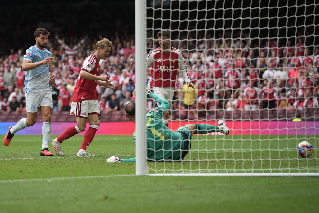 Arsenal's Martin Odegaard, second left, scores his side's third goal during the FA Community Shield final soccer match between Arsenal and Manchester City in Cardiff, Wales, Sunday, Aug.16, 2026. (AP Photo/Alastair Grant)