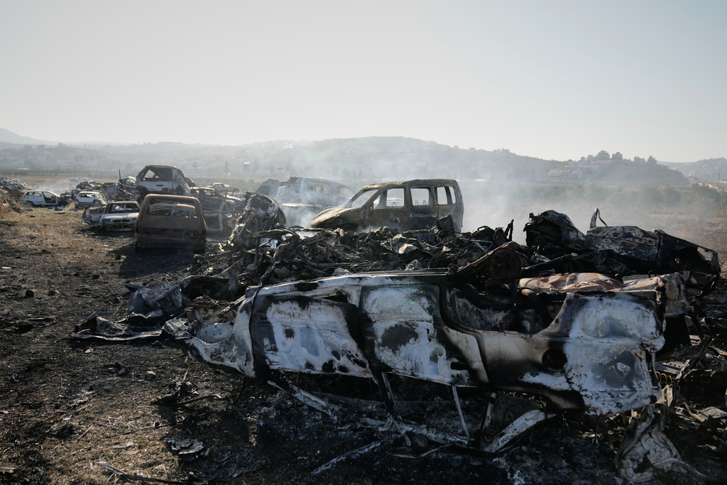 Smoke rises from scorched cars in a scrapyard that was set ablaze the night before by who local residents alleged were Israeli settlers in the town of Huwara near the West Bank city of Nablus, Friday, Nov. 21, 2025. (AP Photo/Nasser Nasser)