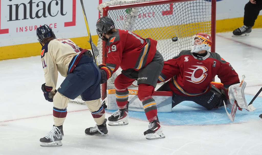 Montreal Victoire forward Abby Roque (11) scores on Ottawa Charge goalie Gwyneth Philips (33) as forward Brianne Jenner (19) defends during the third period of game 4 PWHL Walter Cup final hockey game in Ottawa, Wednesday, May 20, 2026. (Adrian Wyld/The Canadian Press via AP)