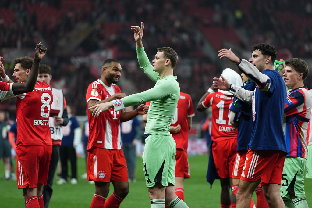 Bayern's goalkeeper Manuel Neuer celebrates with team mates after the German Soccer Cup semifinal match between Bayer Leverkusen and Bayern Munich in Leverkusen, Germany, Wednesday, April 22, 2026. (AP Photo/Martin Meissner)