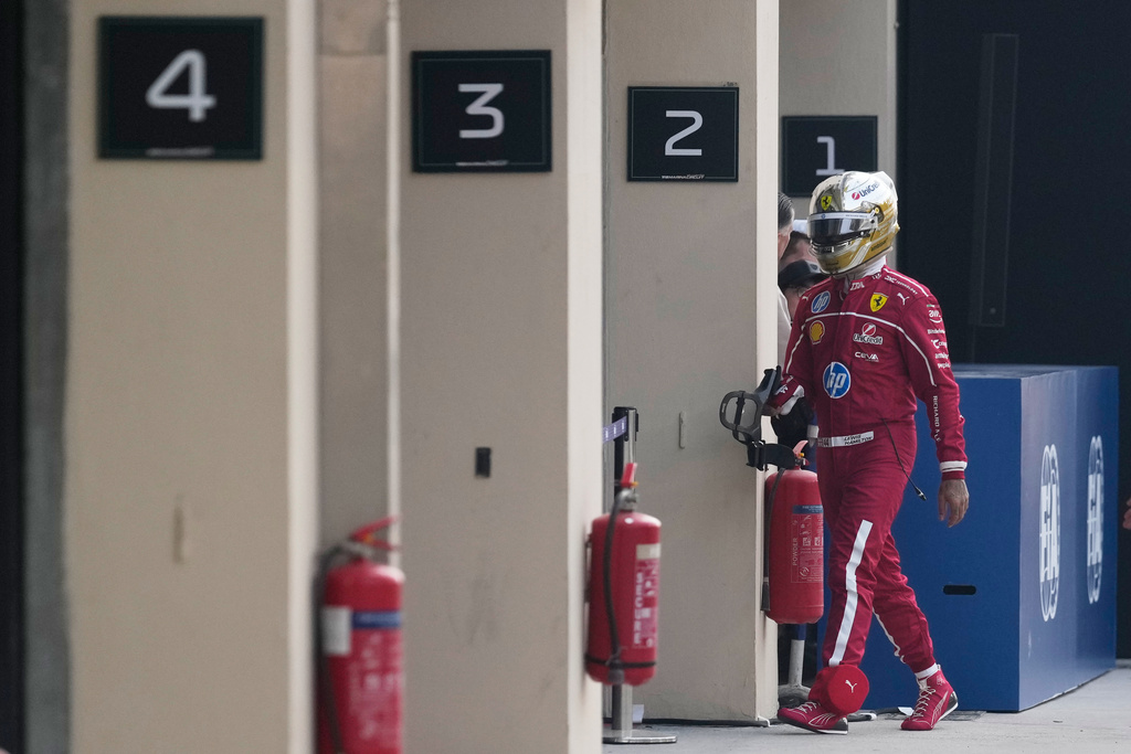 Ferrari driver Lewis Hamilton of Britain walks back to his pits after he crashed into the track wall during the third practice ahead of the Formula One Abu Dhabi Grand Prix at the Yas Marina Circuit in Abu Dhabi, UAE, Saturday, Dec. 6, 2025. (AP Photo/Altaf Qadri)