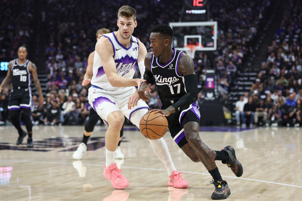 Sacramento Kings guard Dennis Schröder (17) drives to the basket with Utah Jazz center Kyle Filipowski, left, defending during the first half of an NBA basketball game Friday, Oct. 24, 2025, in Sacramento, Calif. (AP Photo/Sara Nevis)