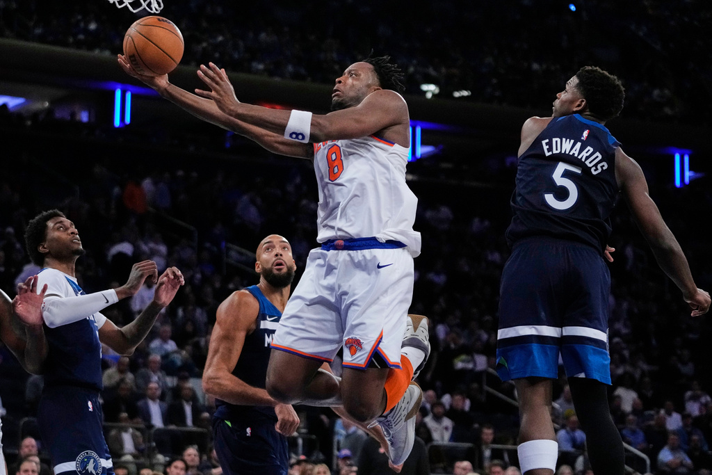 New York Knicks' Og Anunoby drives past Minnesota Timberwolves' Anthony Edwards, right, Rudy Gobert, center, and Jaden McDaniels, left, during the second half of an NBA basketball game Wednesday, Nov. 5, 2025, at Madison Square Garden in New York. (AP Photo/Frank Franklin II)