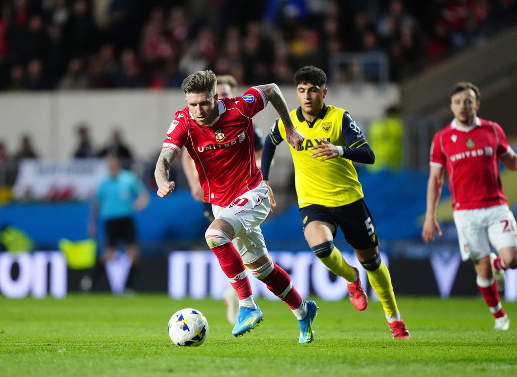 Wrexham's Josh Windass gets away from Oxford United's Yunus Konak before scoring their first goal during the EFL Championship soccer match between Oxford United and Wrexham, Tuesday, April 28, 2026, in Oxford, England. (David Davies/PA via AP)