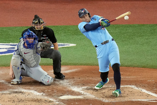 Toronto Blue Jays' George Springer (4) hits an RBI single against the Los Angeles Dodgers during the third inning in Game 6 of baseball's World Series in Toronto on Friday, Oct. 31, 2025. (Chris Young/The Canadian Press via AP) Toronto Blue Jays' George Springer (4) hits an RBI single against the Los Angeles Dodgers during the third inning in Game 6 of baseball's World Series in Toronto on Friday, Oct. 31, 2025. (Chris Young/The Canadian Press via AP)