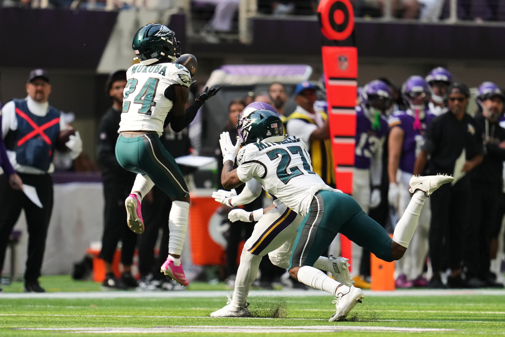 Philadelphia Eagles safety Andrew Mukuba intercepts a pass during the first half of an NFL football game against the Minnesota Vikings, Sunday, Oct. 19, 2025, in Minneapolis. (AP Photo/Abbie Parr)