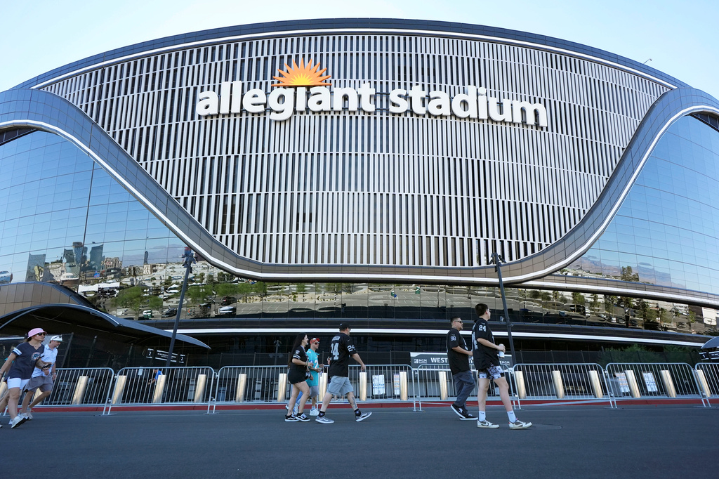 Fans walk outside Allegiant Stadium before an NFL football game between the Las Vegas Raiders and the Miami Dolphins, Sunday, Sept. 13, 2026, in Las Vegas. (AP Photo/Ross D. Franklin)