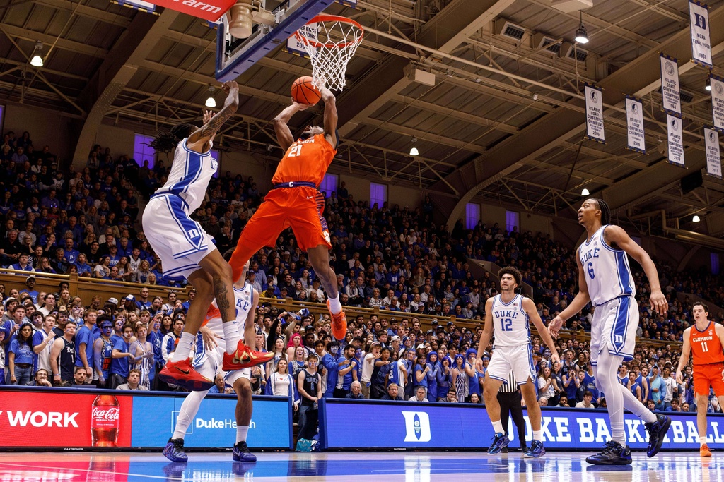 Clemson's Ace Buckner (21) attempts a shot as Duke's Isaiah Evans, left, defends during the first half of an NCAA college basketball game in Durham, N.C., Saturday, Feb. 14, 2026. (AP Photo/Ben McKeown)