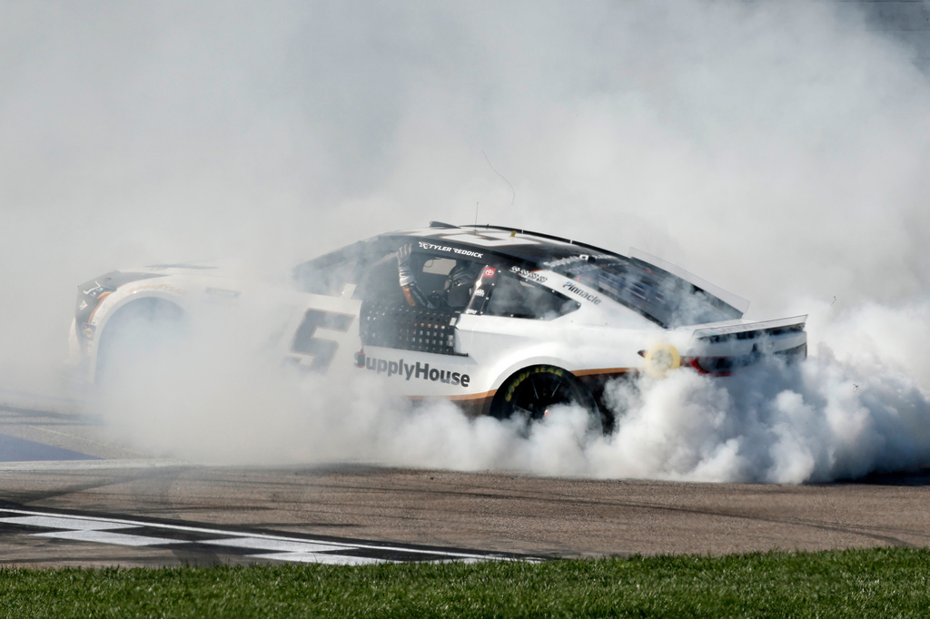 Tyler Reddick does a burnout after winning a NASCAR Cup Series auto race at Kansas Speedway in Kansas City, Kan., Sunday, April 19, 2026. (AP Photo/Colin E. Braley)