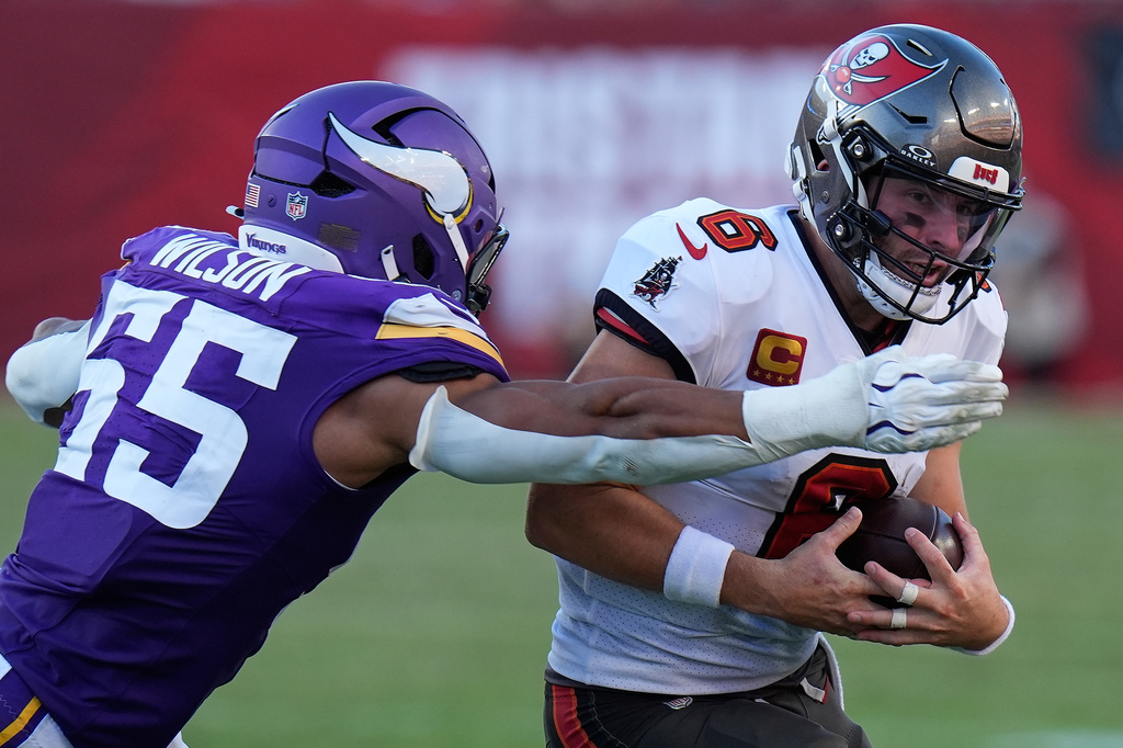 Tampa Bay Buccaneers quarterback Baker Mayfield (6) is tackled by Minnesota Vikings linebacker Eric Wilson (55) during the second half of an NFL football game in Tampa, Fla., Sunday, Sept. 27, 2026. (AP Photo/Chris O'Meara)